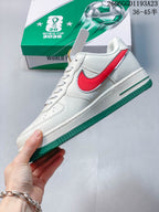 Side view of the white sneaker with red side accent and green outsole.