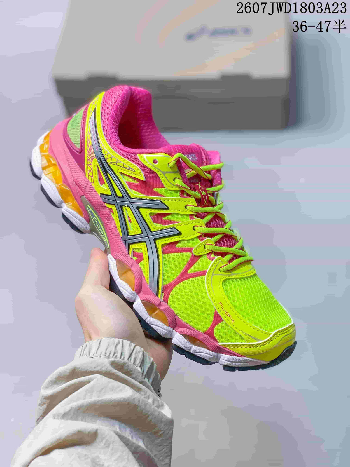 Neon green and pink ASICS Gel-Nimbus 16 sneaker shown from the side and top.