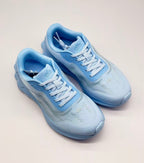 Top three-quarter view of the pair showing the laces, tongues and textured uppers.