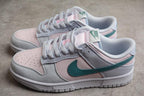 Pair of low-top sneakers shown from above and the side in white, pale pink and green.