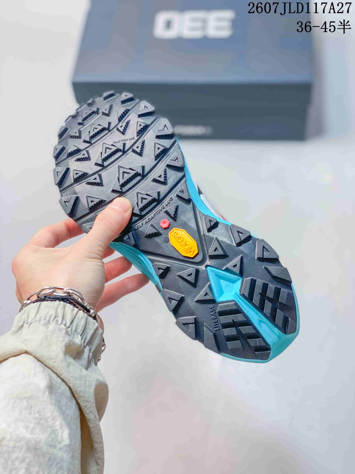 Underside view showing the lugged outsole, triangular traction patterns, and visible Vibram branding.