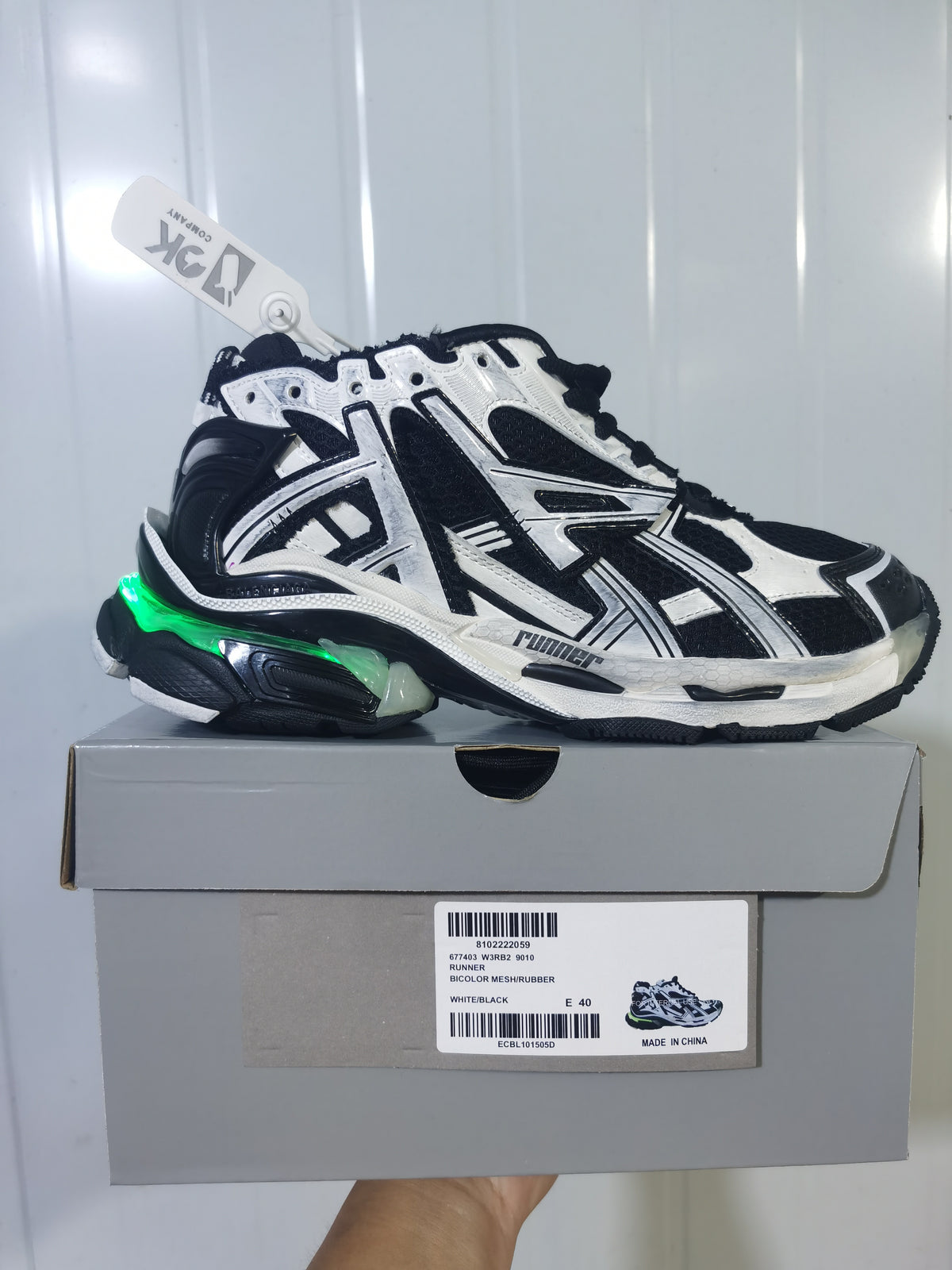 Puma 9010 white and black runner sneaker shown on its box, with the box label visible.