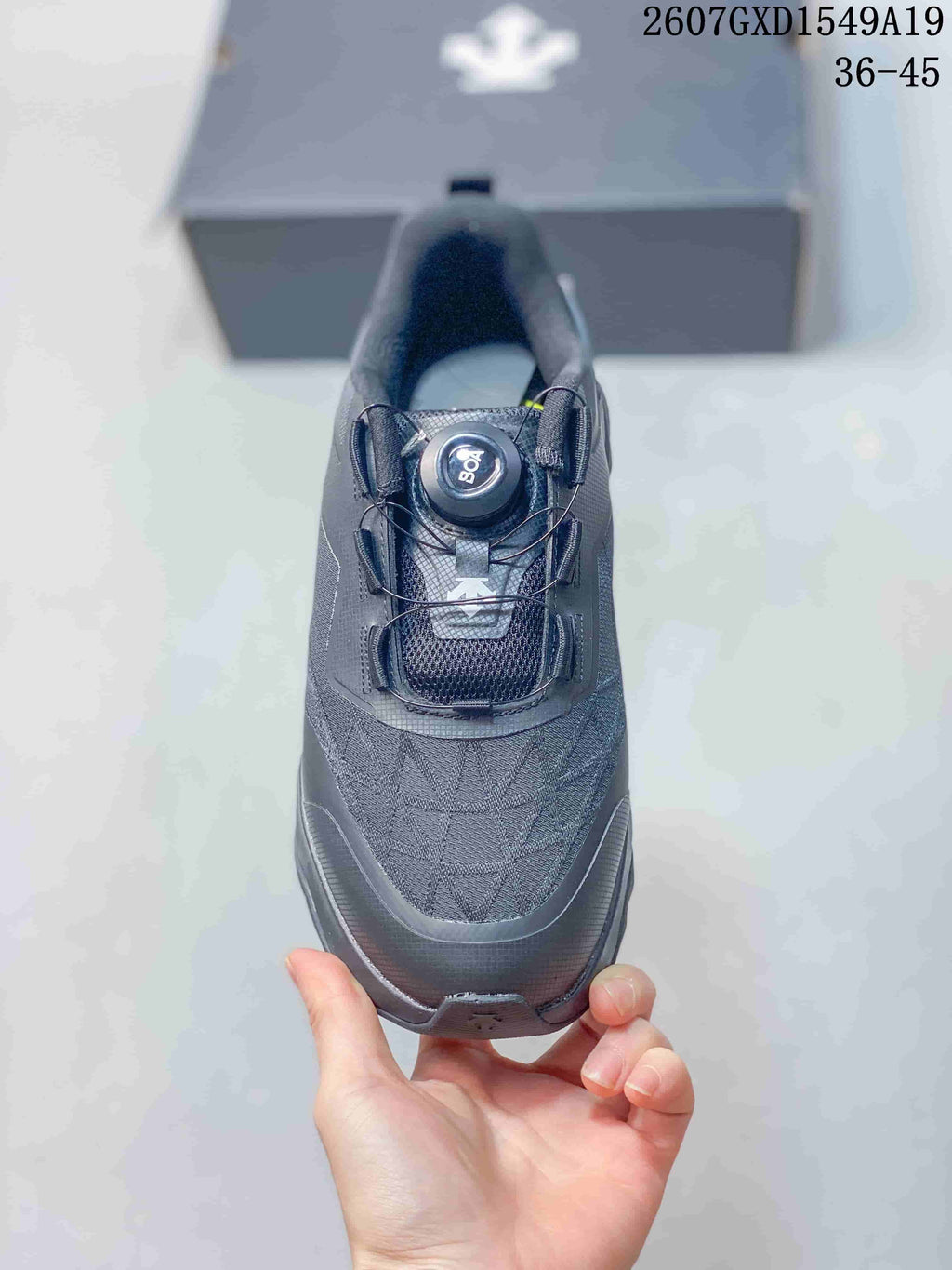 Top view of the black sneaker showing the dial-style closure and textured upper.