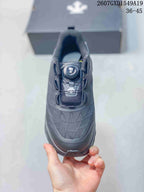 Top view of the black sneaker showing the dial-style closure and textured upper.