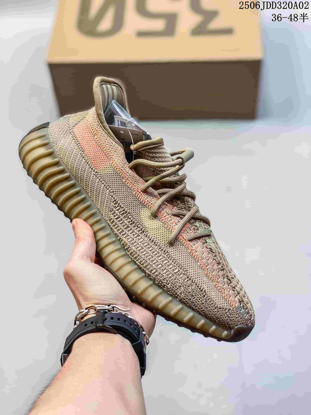 Tan and multicolor Adidas Yeezy-style sneaker with a contrasting side stripe and ridged sole.