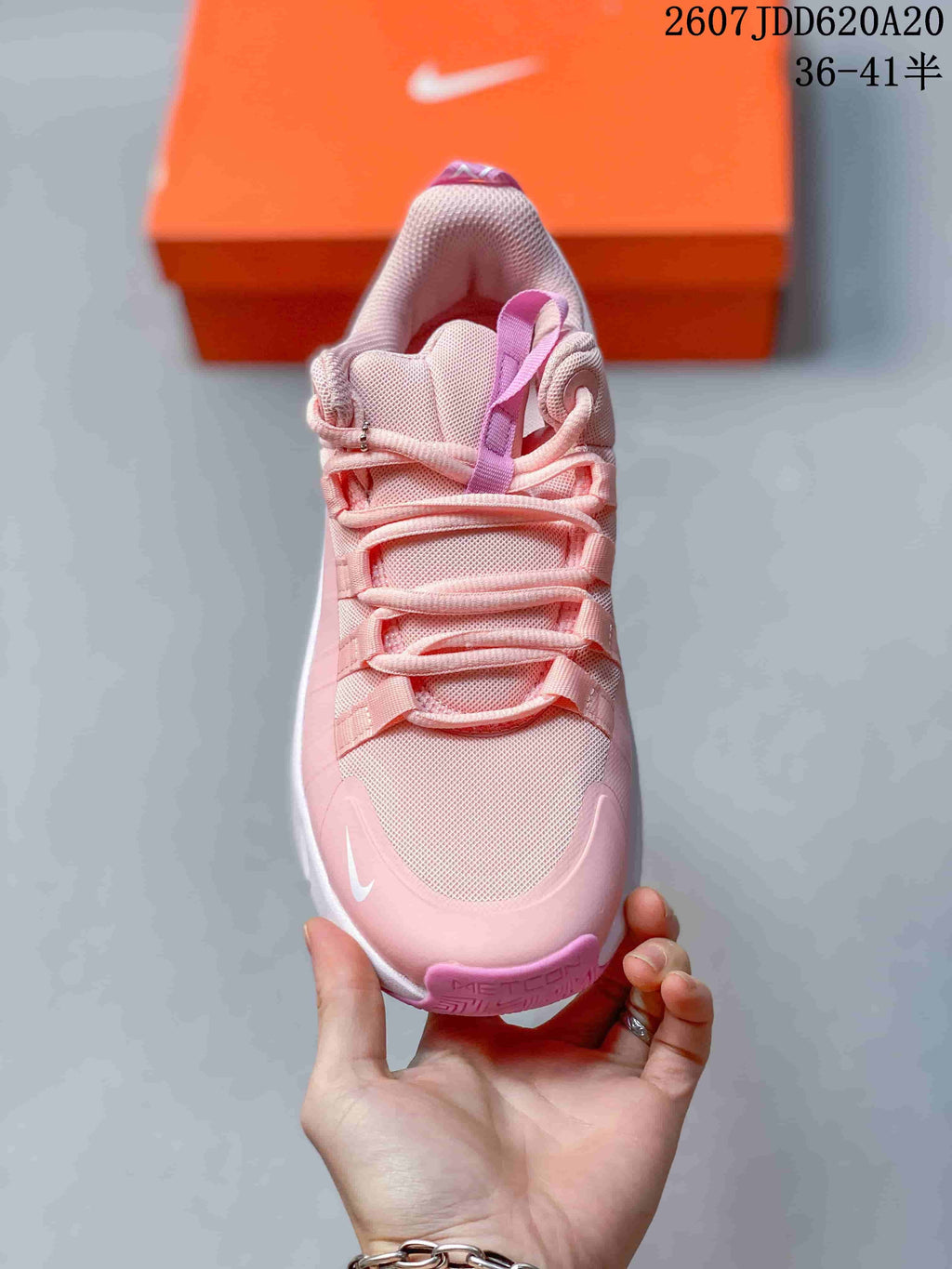 Top view showing the pink mesh-style upper, layered laces, padded tongue, and white toe branding.