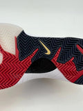 Close-up of the shoe outsole showing black, red, and translucent sections with patterned tread.