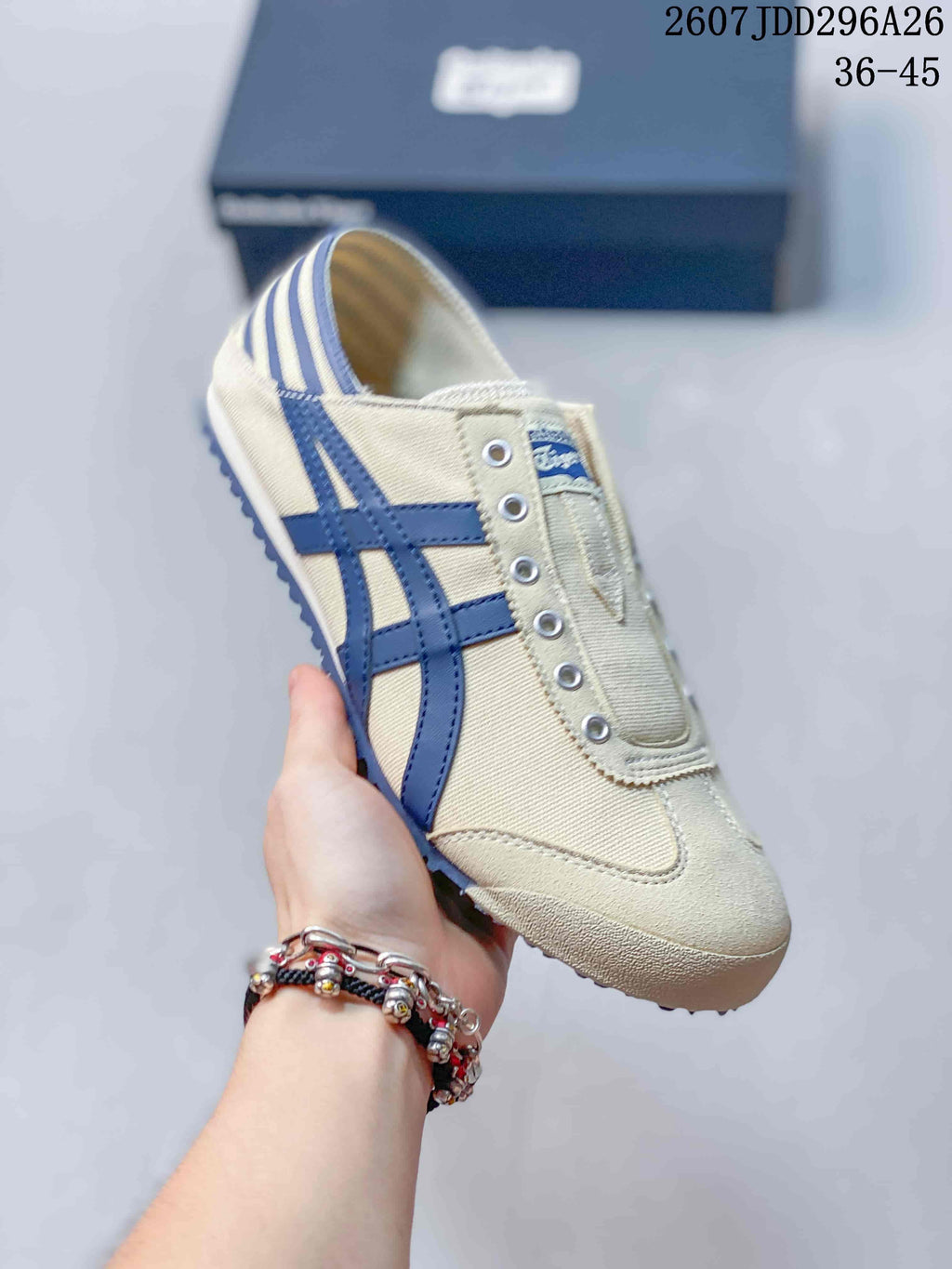 Angled side view of the cream and navy Onitsuka Tiger sneaker, showing the striped heel panel, side stripes and textured outsole; image text shows size range 36-45.