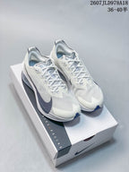 Pair of white and light gray Nike running shoes displayed on a Nike shoe box, with dark navy accents and the code 2607JLD978A18 visible above.