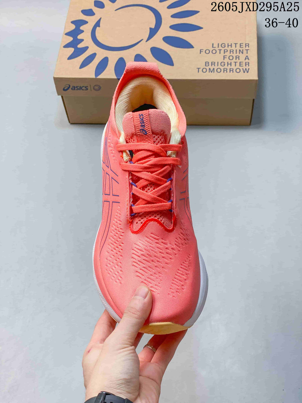 Top view of the coral-pink lace-up shoe with knitted-looking upper