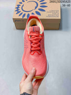Top view of the coral-pink lace-up shoe with knitted-looking upper