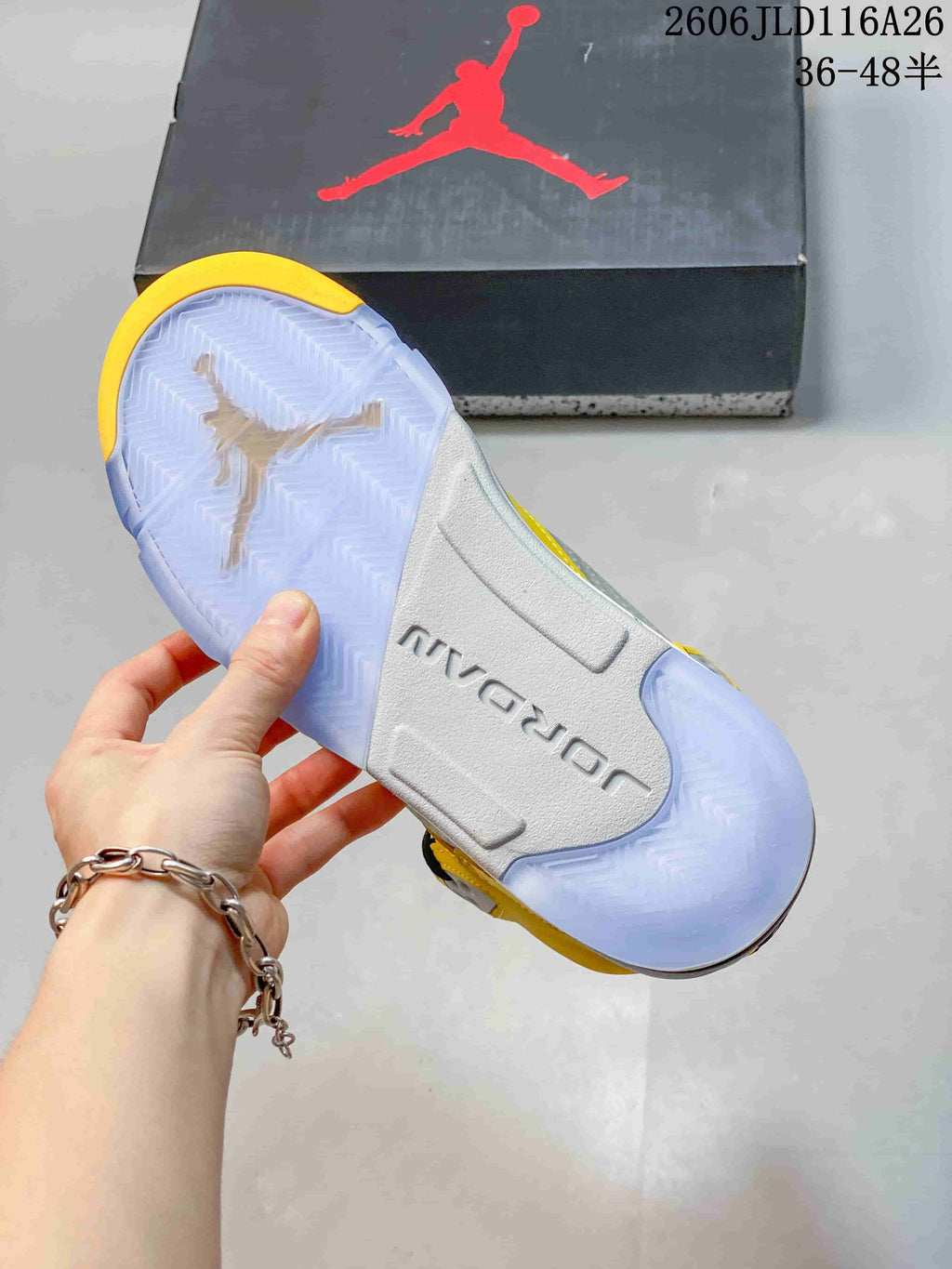 Bottom view of the sneaker showing a translucent outsole and Jordan branding