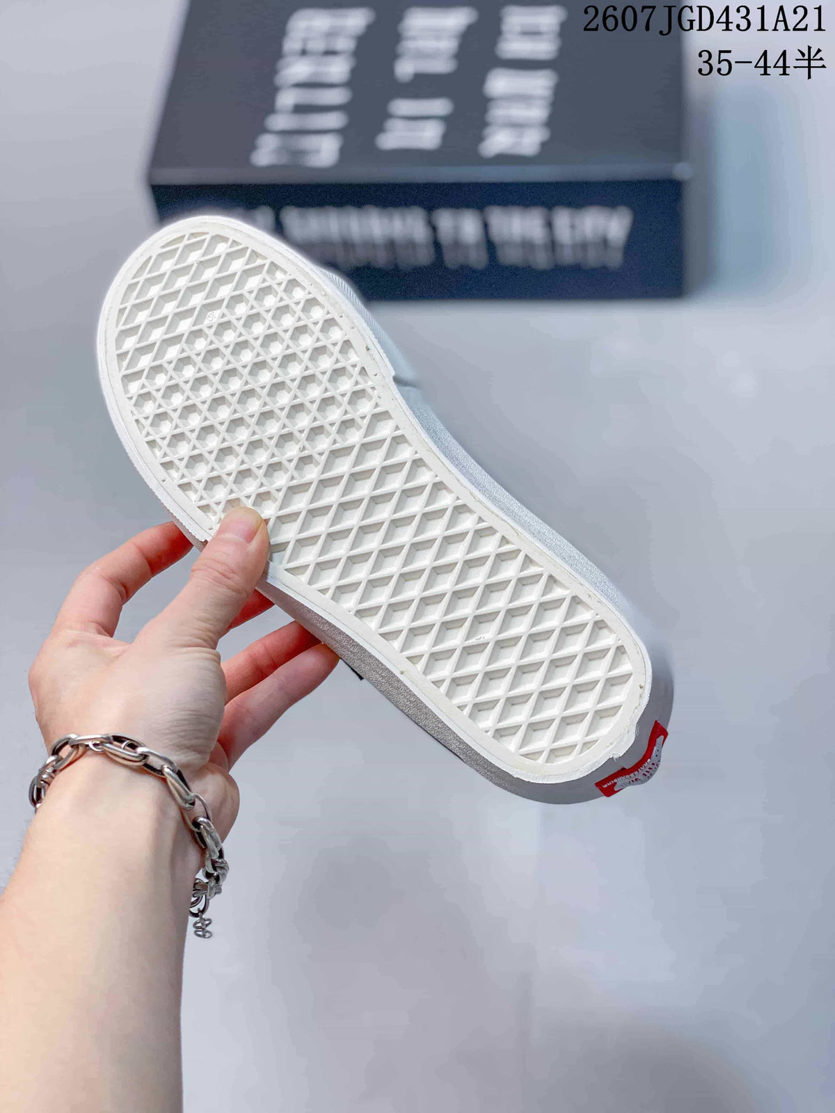 Underside of a blue sneaker showing the white waffle-pattern rubber outsole.