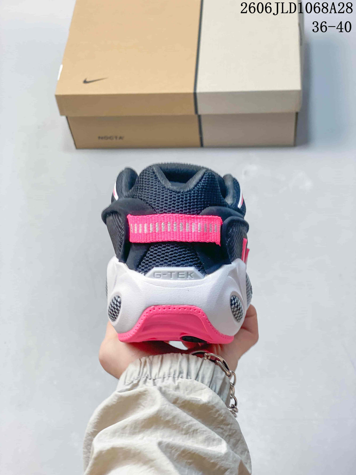 Rear view of the sneaker showing the pink heel tab and white and pink heel details
