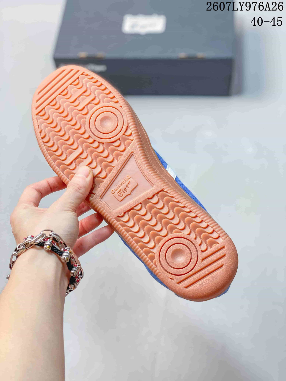 Close-up of the textured gum-colored outsole with circular traction details and molded branding.