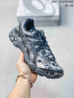 Angled side view showing the dark gray floral upper and layered sole.