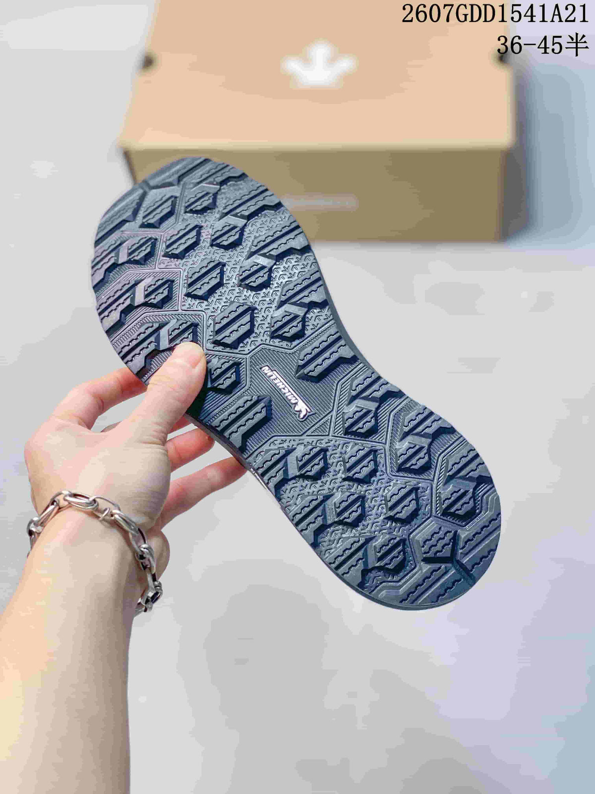 Close-up of the patterned outsole with raised geometric tread blocks.
