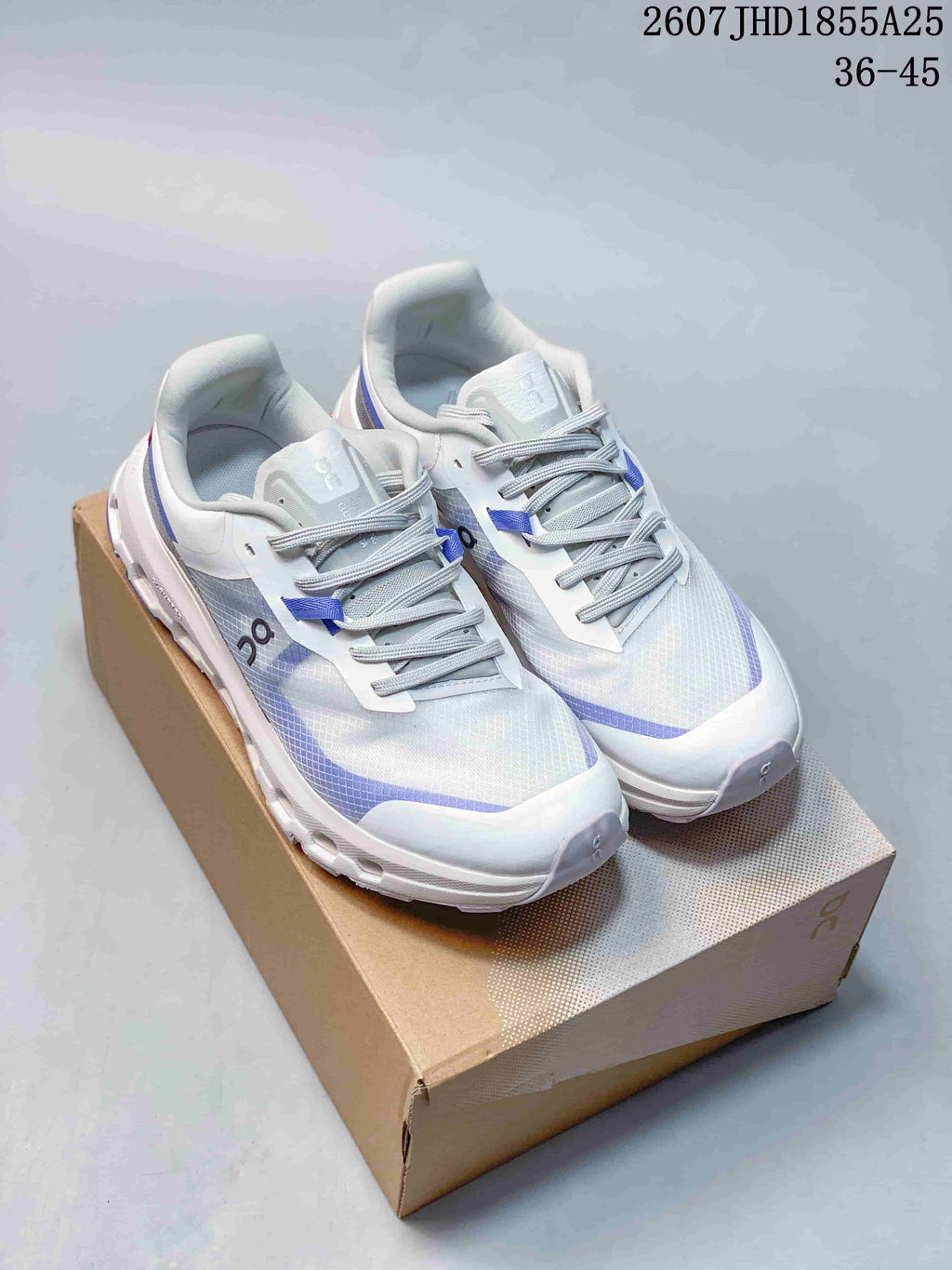 Pair of white and blue On Cloudvista 2 sneakers displayed on a shoebox, with the listed range 36–45 and style code 2607 JHD1855A25 visible.