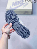 Close view of the dark navy rubber outsole with circular traction grooves and block-pattern tread.