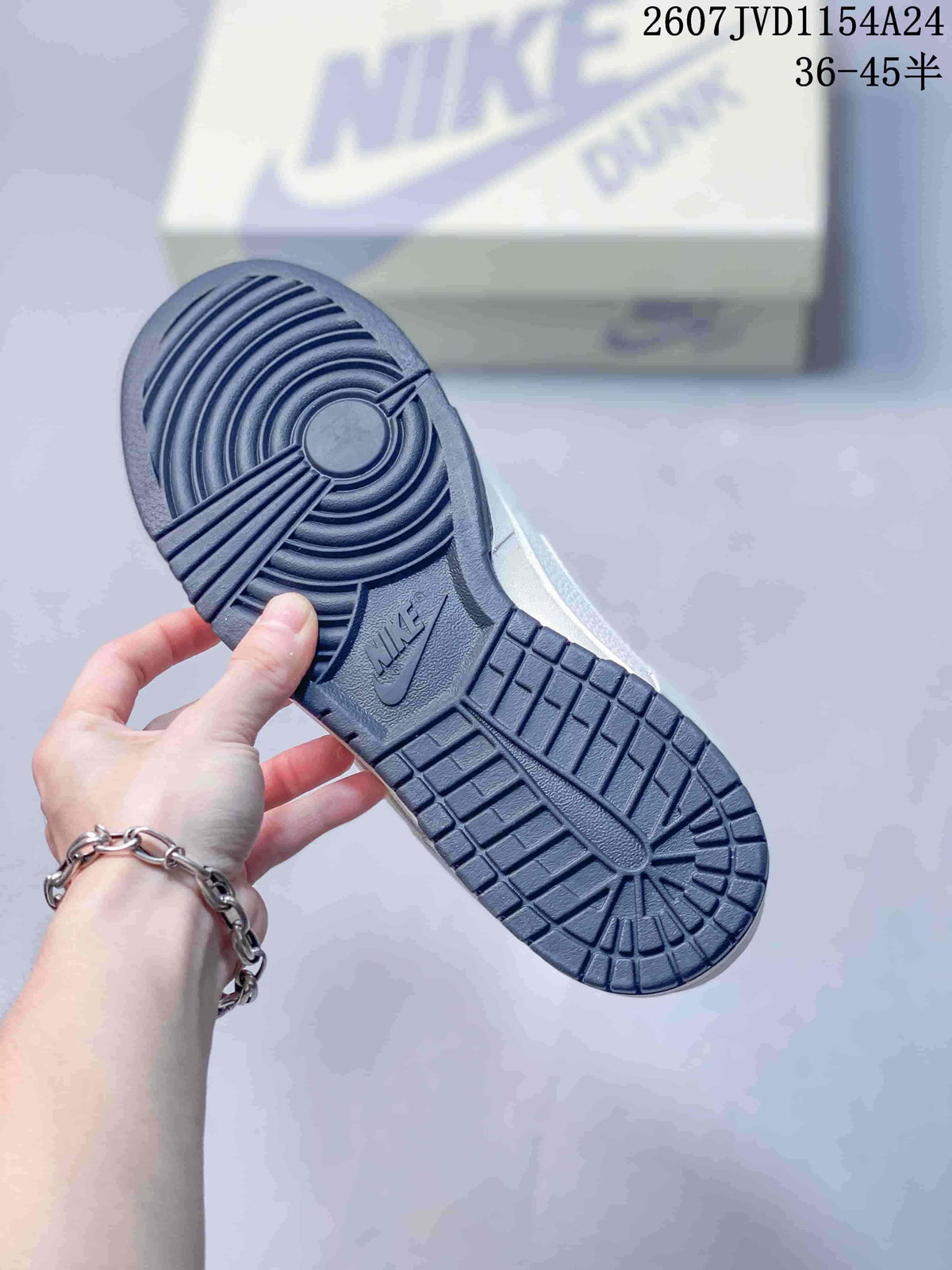 Close view of the dark navy rubber outsole with circular traction grooves and block-pattern tread.