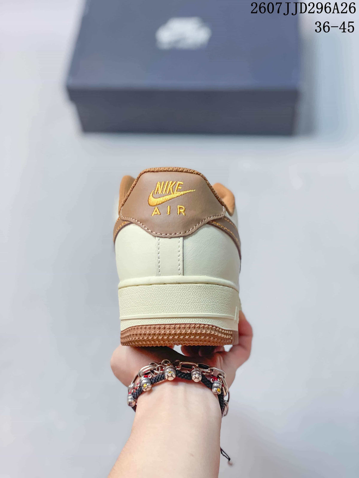 Rear view showing the cream heel, brown collar, gold Nike Air branding, and gum outsole.