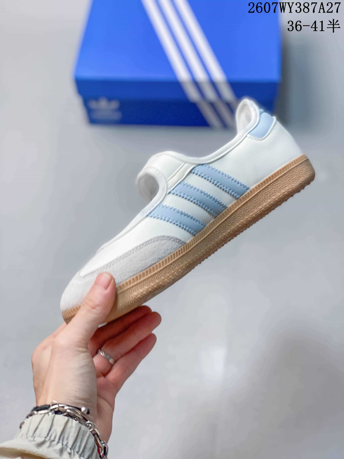 Side profile of the white sneaker with light blue stripes, suede-look toe overlay, and gum-colored sole.