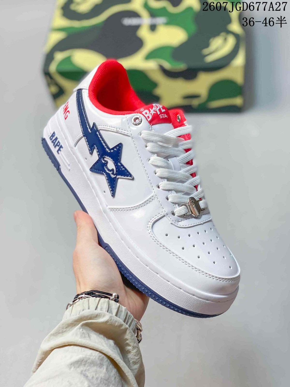 Angled side view of a white BAPE Sta sneaker with blue star detail, red collar lining and BAPE branding on the midsole.