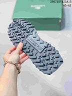 Close view of the sneaker outsole showing a dark lugged tread pattern and Lacoste branding.