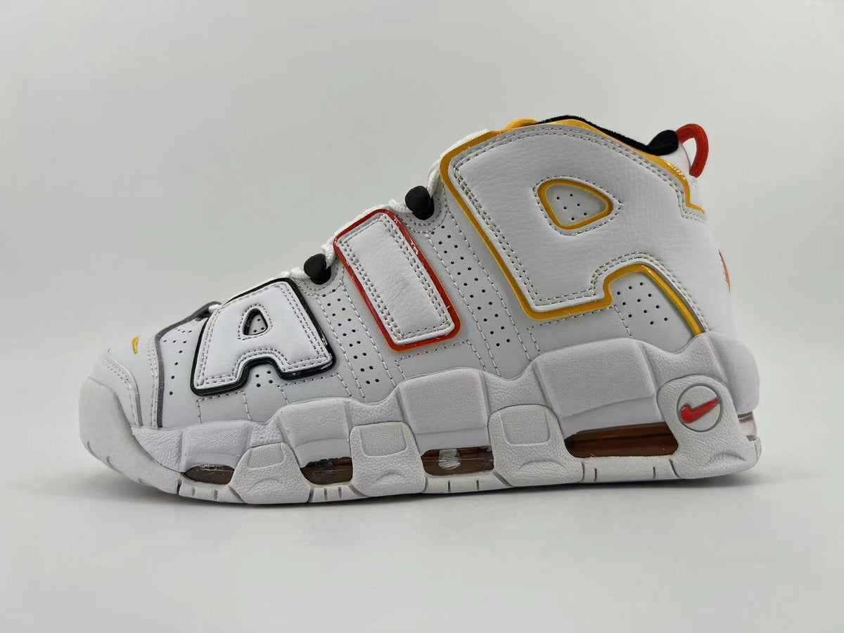 Side view of a white Nike Air More Uptempo sneaker with oversized AIR lettering and red, yellow, and black accents.