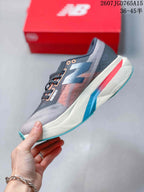 Side profile highlighting the gray upper, layered side branding and multicolor midsole accents.