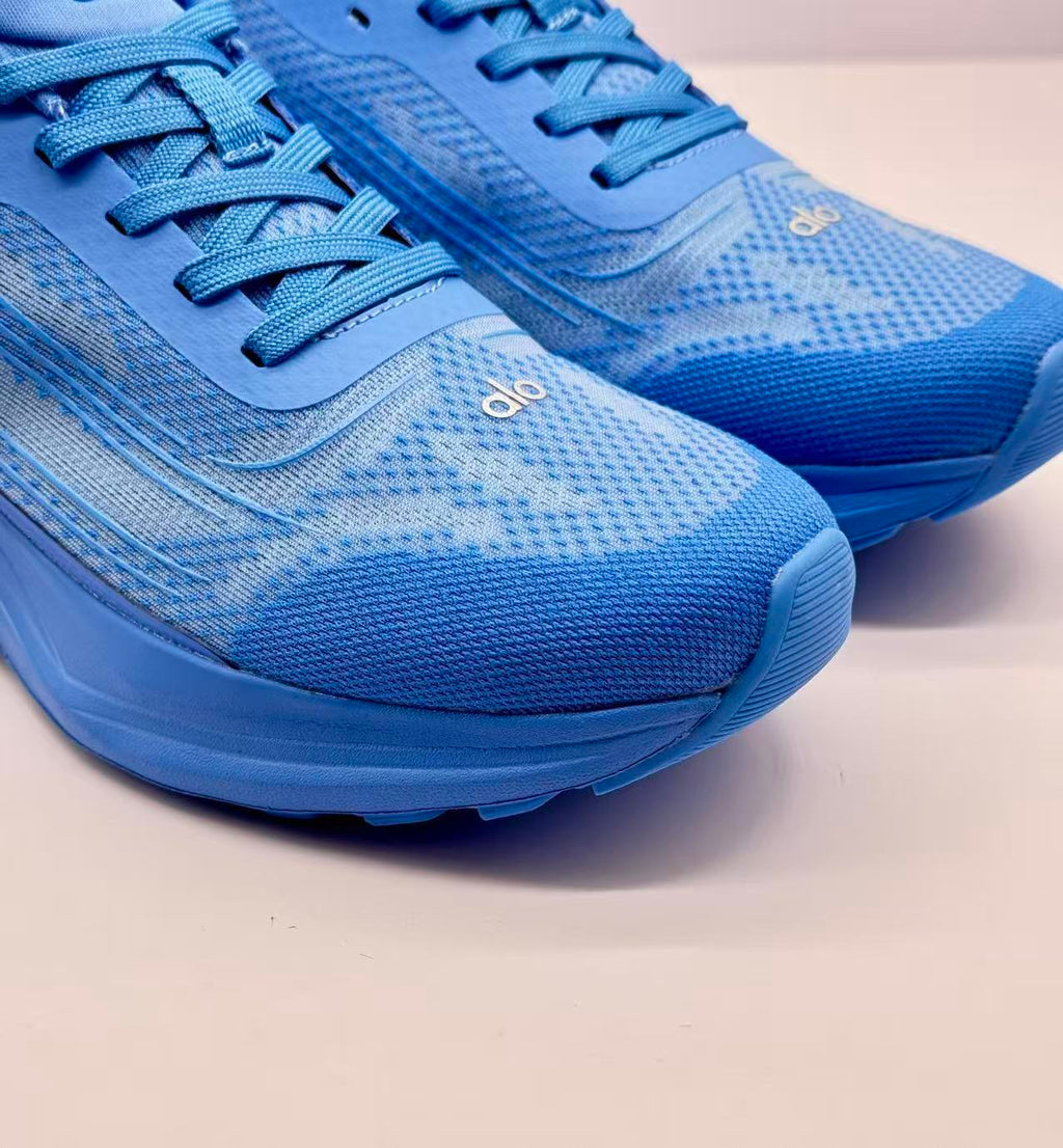 Close-up of the blue textured toe area, laces and Alo branding.