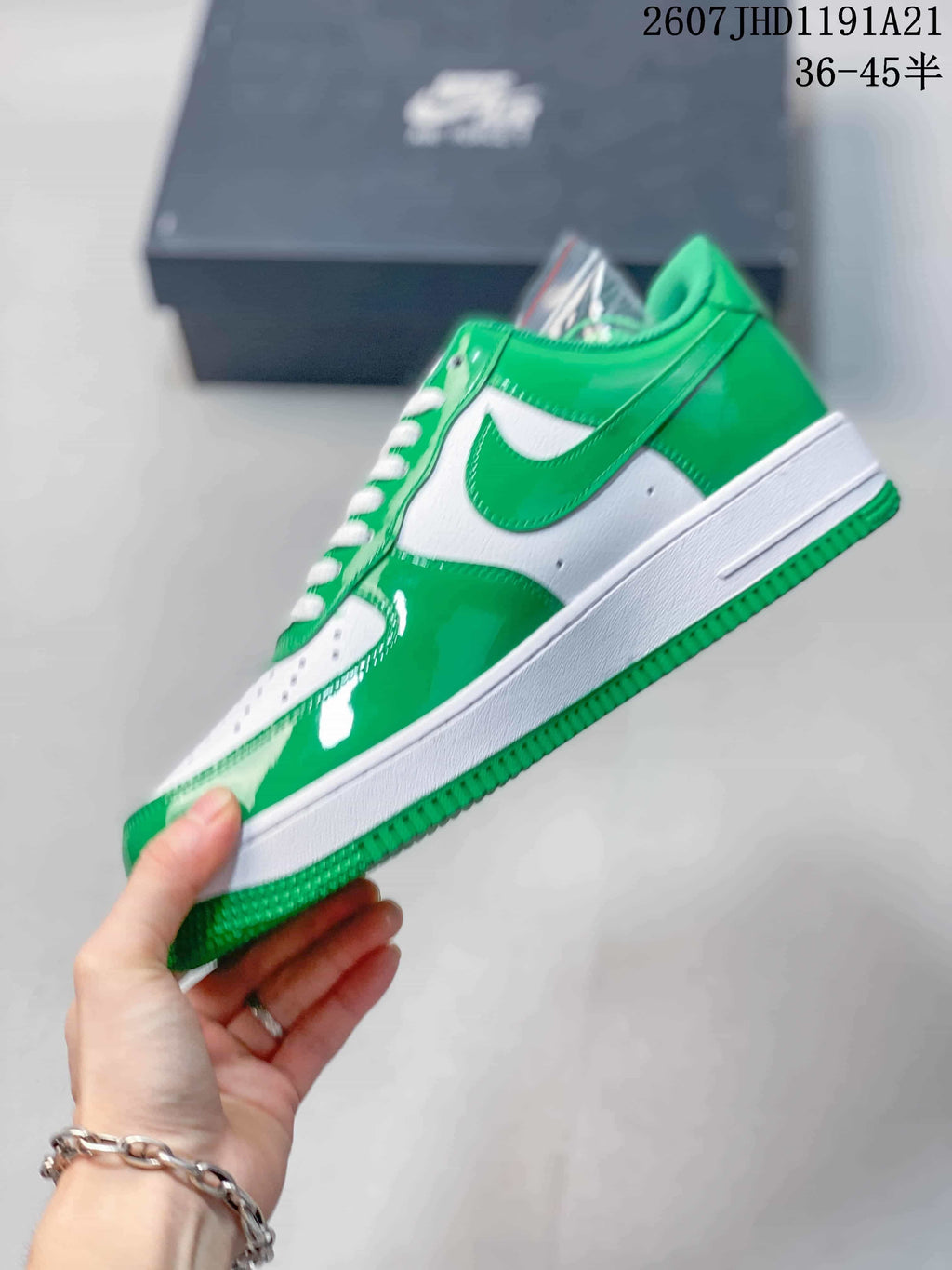Side view showing the green-and-white upper, Nike Swoosh, white midsole, and green outsole.