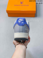 Rear view of a gray and blue low-top sneaker with Nike Air branding.