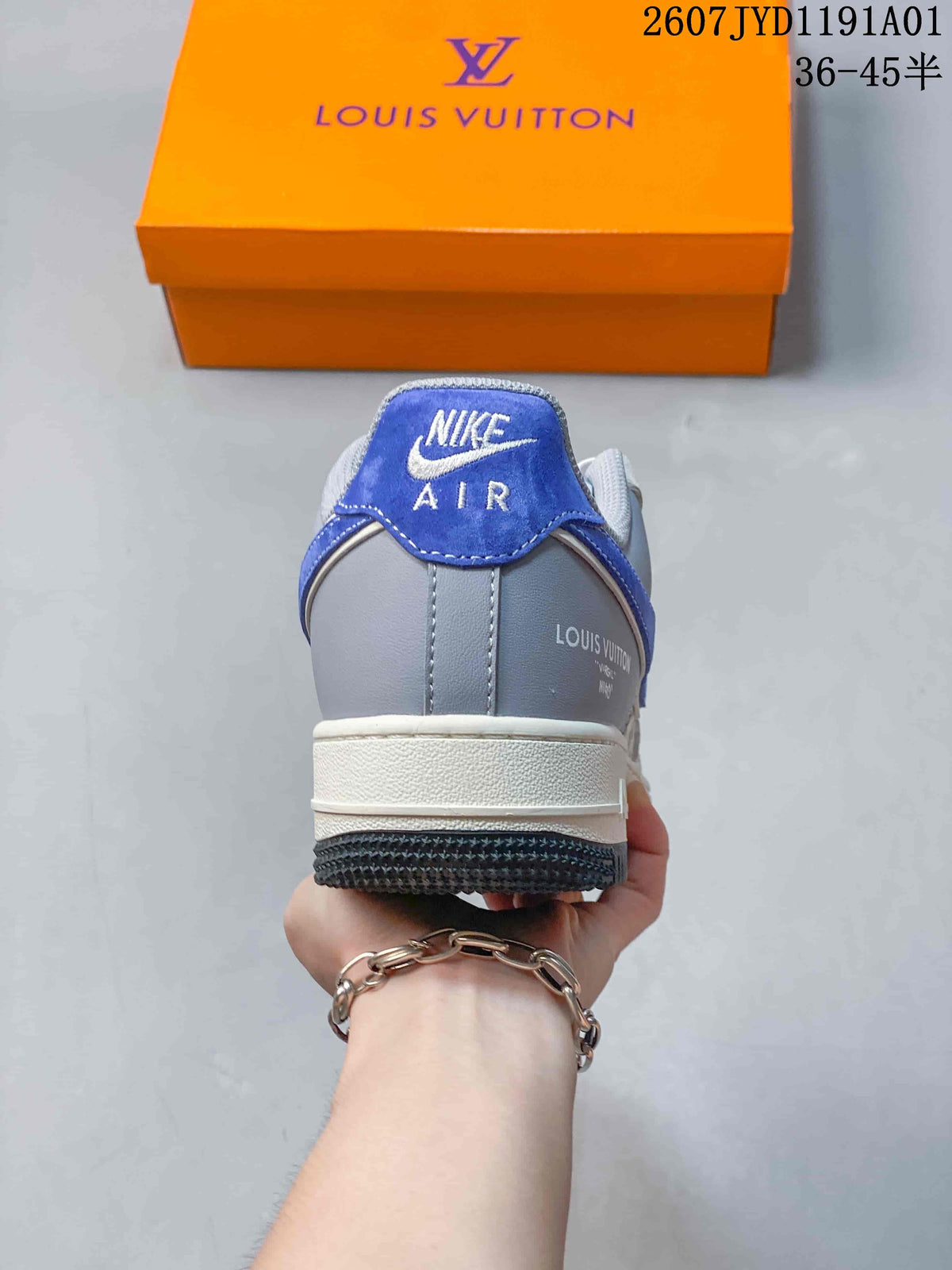 Rear view of a gray and blue low-top sneaker with Nike Air branding.