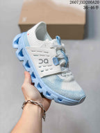 Side view of a white and light blue On Cloudswift Amp sneaker showing the layered upper and sculpted sole.