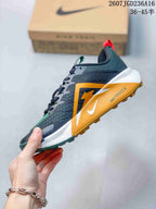 Side view of the dark gray trail sneaker showing the orange Nike Swoosh, white midsole, lugged outsole, and ReactX side branding.