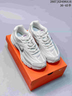 Pair of white and grey Nike Initiator sneakers displayed on an orange shoebox; overlay text shows 36–45 sizing.