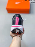Rear view showing the black heel, pink vertical detail, and layered white outsole.