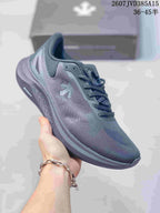 Side view of a grey Descente EASE WIRE sneaker showing the mesh-like upper, lace system and textured sole.