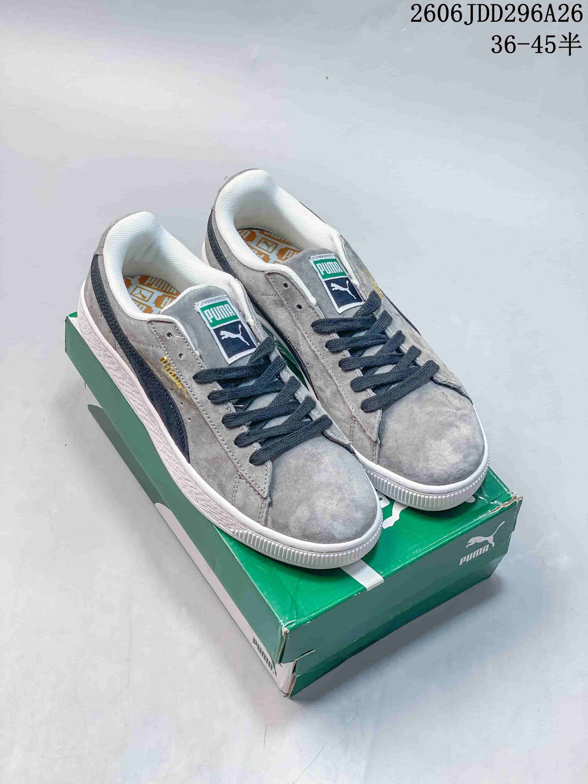 Pair of gray Puma low-top sneakers with dark navy accents displayed on a green Puma shoe box; overlay text shows style code 2606JDD296A26 and size range 36–45.5.