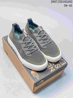 Pair of gray and olive The North Face Dune sneakers with lace-up fronts and light soles.