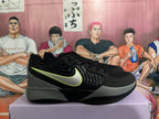 Side profile of a black and gray Nike sneaker with a glossy side panel and lime-accented swoosh.