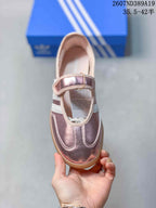 Top view of the metallic pink sneaker showing the rounded toe, stitched overlays, and adjustable strap.