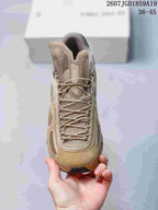 Top view of the beige sneaker showing the mesh tongue, tonal laces, and layered toe construction.