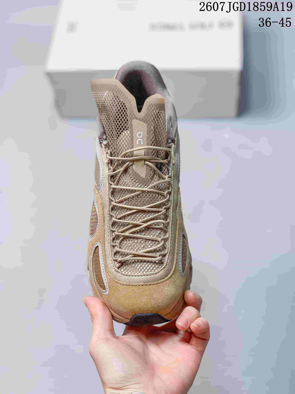 Top view of the beige sneaker showing the mesh tongue, tonal laces, and layered toe construction.