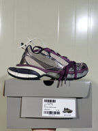Side profile of the purple and grey sneaker placed on its box; the box label shows model reference 1269 and sample size C 38.