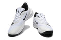 Pair of white and black Nike Precision 7 basketball shoes shown from above