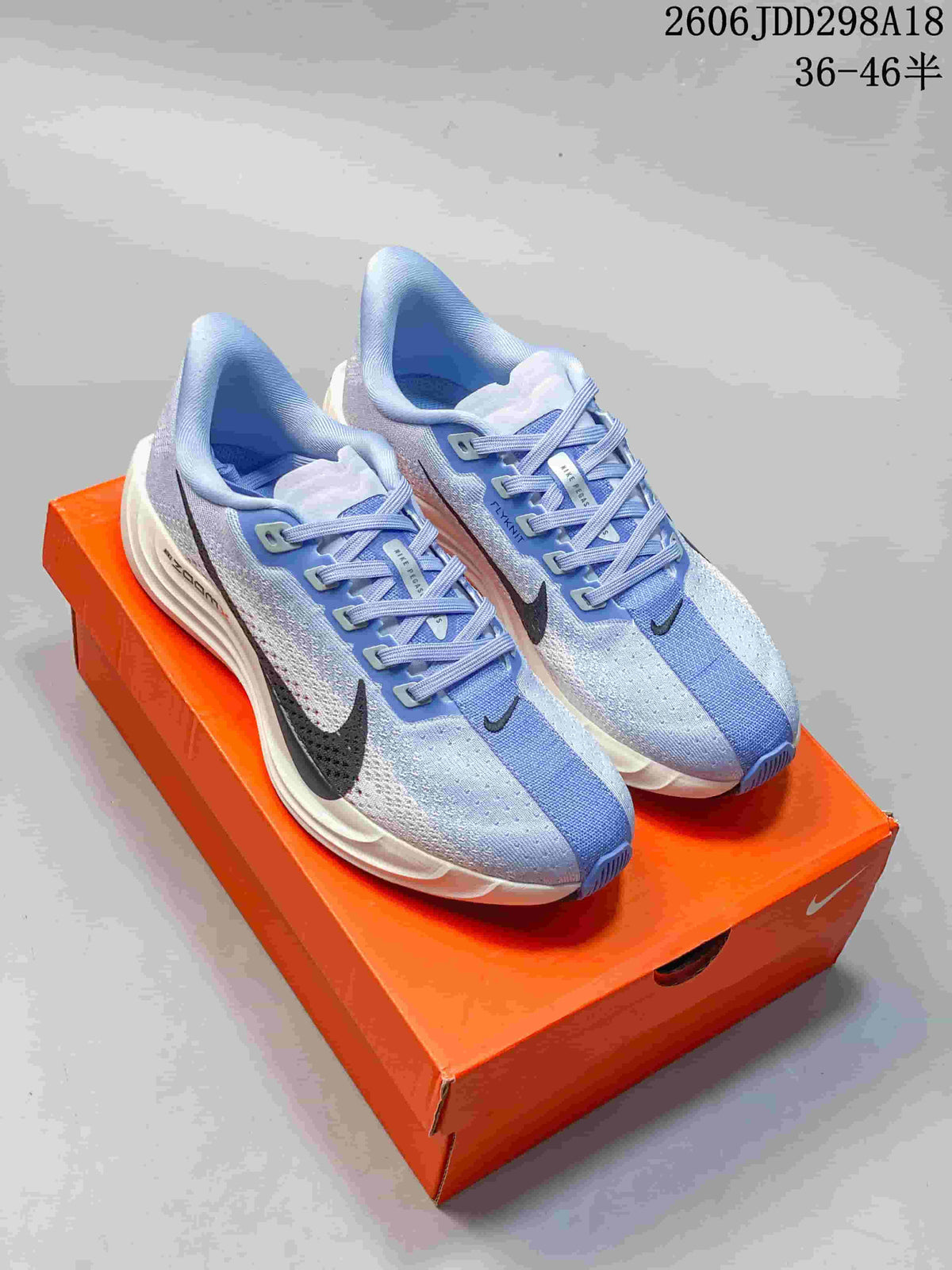 Light blue Nike Pegasus Plus Next Nature shoes with dark Swoosh accents
