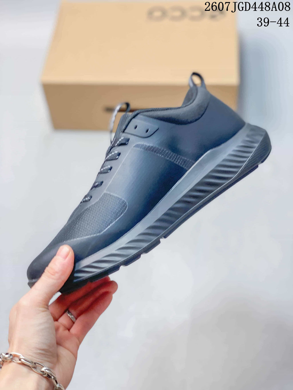 Side view showing the dark gray upper panels and ridged outsole