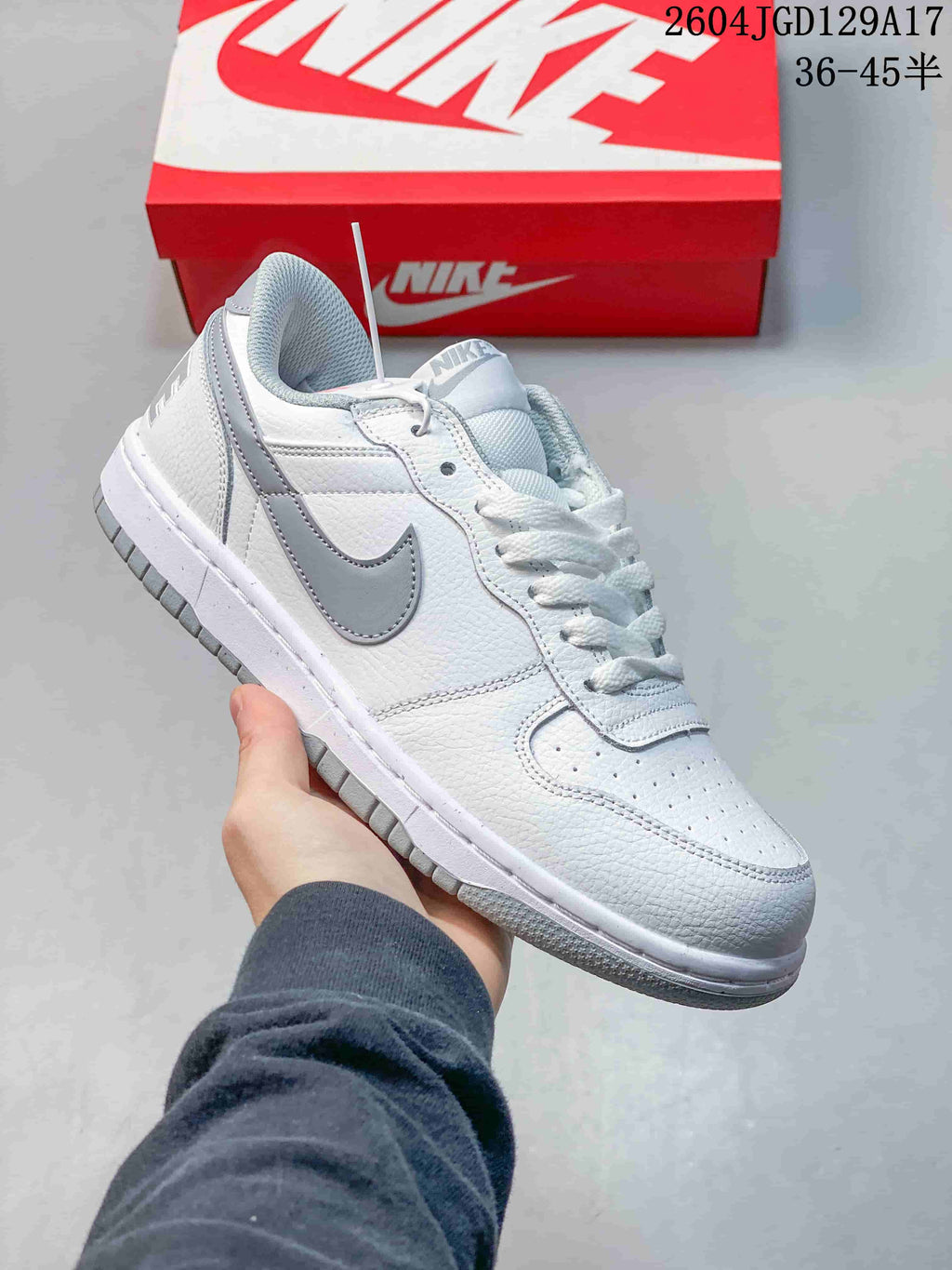 Close-up of a white low-top sneaker with gray Swoosh and outsole details